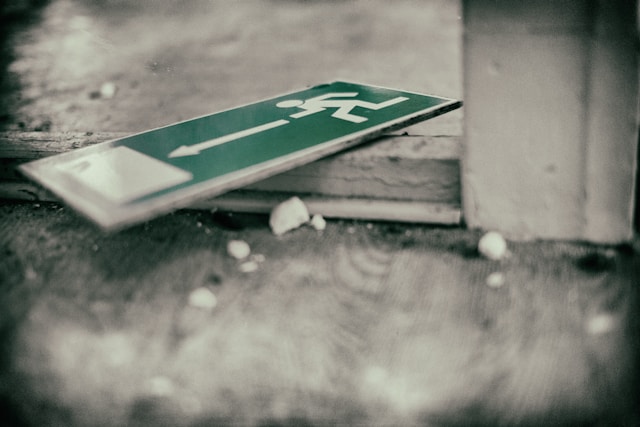 Green emergency exit sign on floor