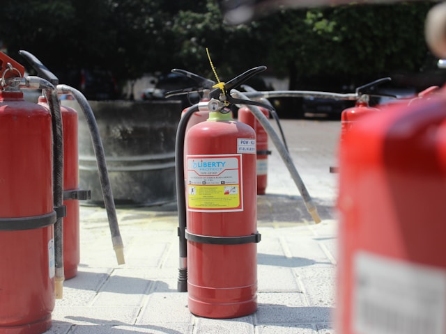 Red Fire Extinguishers on the pavement : Fire Strategy from North West Fire Solutions Ltd